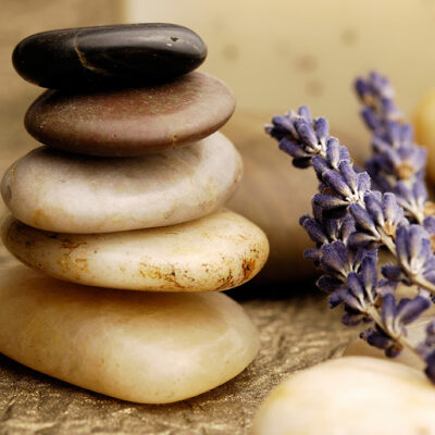 Image of remedial massage hot stones in a cairn